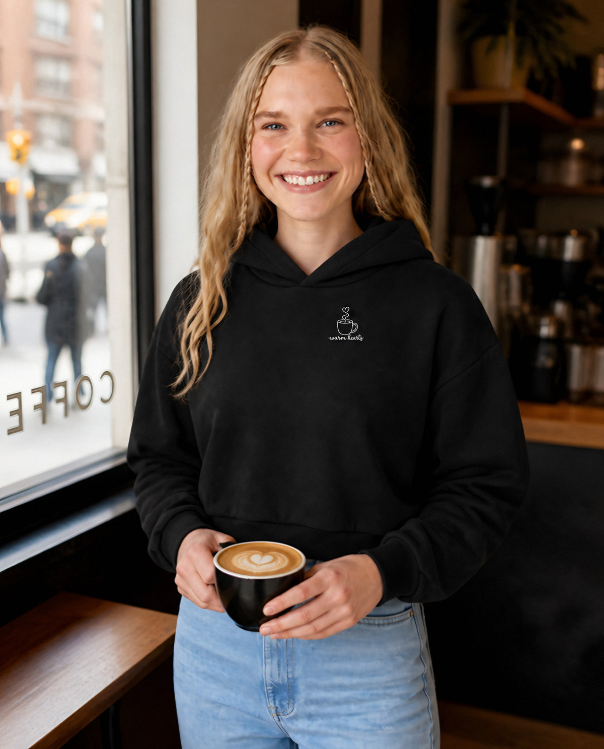 Warm Hearts minimalist crop hoodie for women in Black, worn by model, lifestyle photo