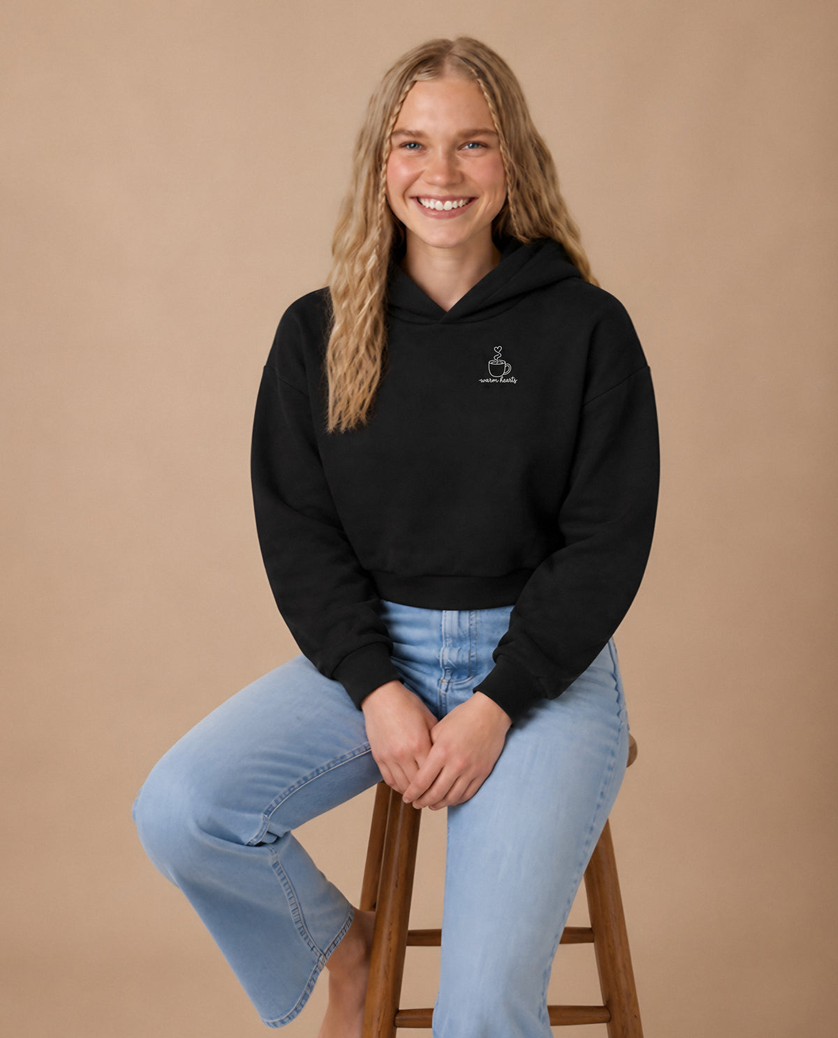 Warm Hearts minimalist crop hoodie for women in Black, worn by model, studio photo