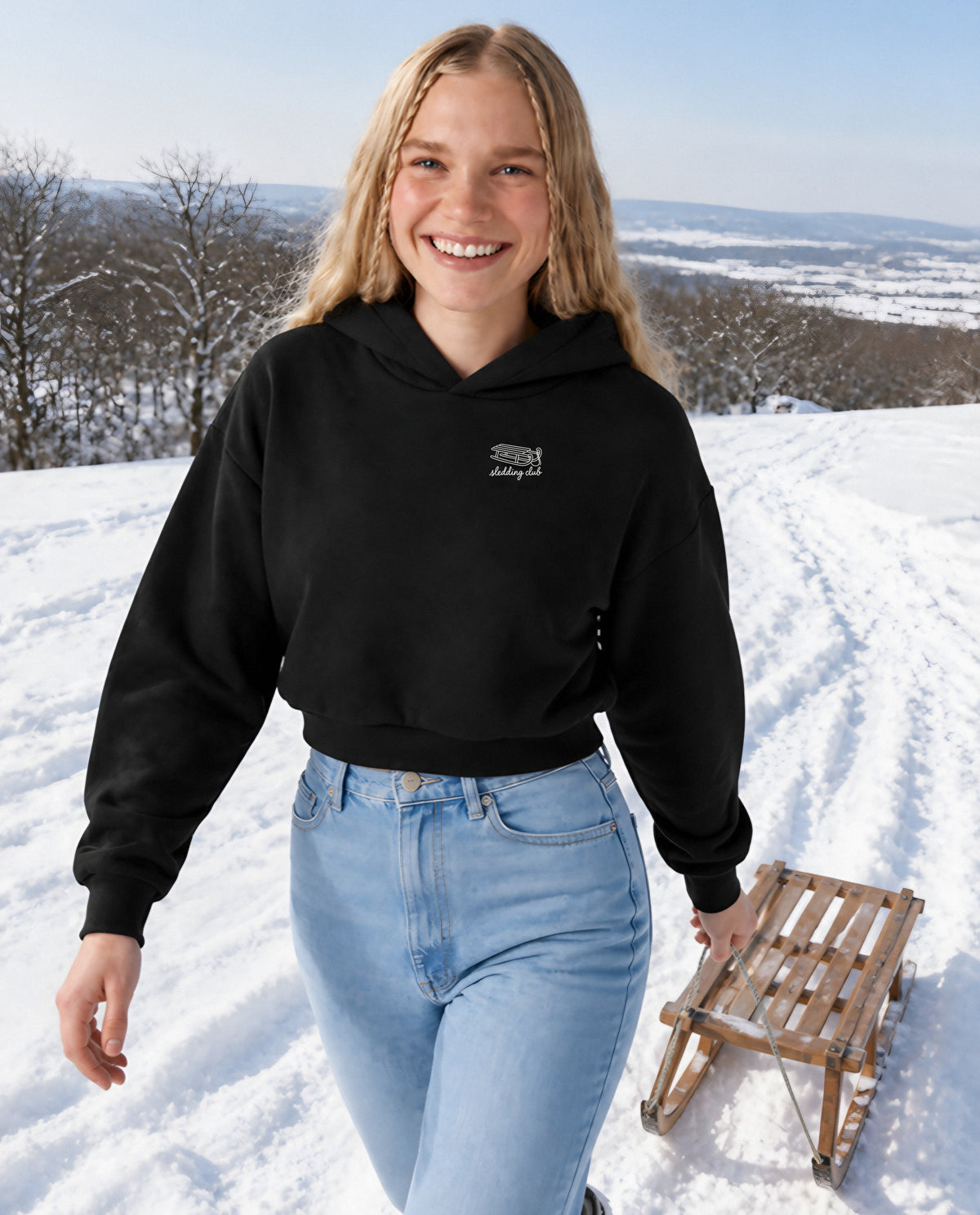 Sledding Club minimalist crop hoodie for women in Black, worn by model, lifestyle photo
