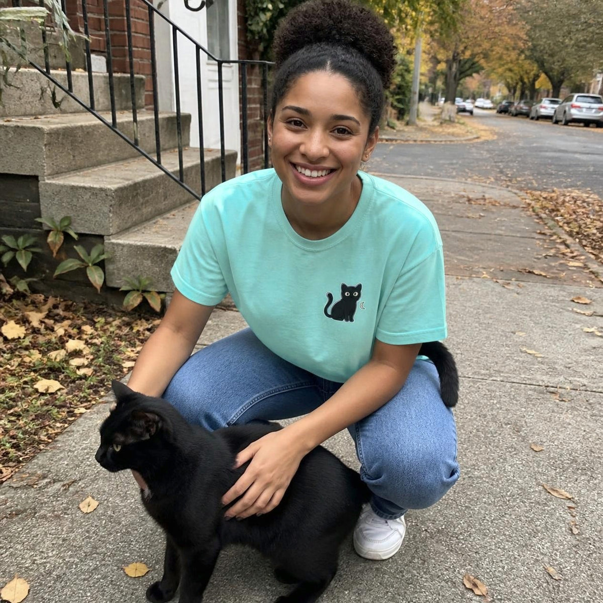 Woman wearing the chalky mint Black Cat boxy crop tee, lifestyle photo (Color: Chalky Mint)