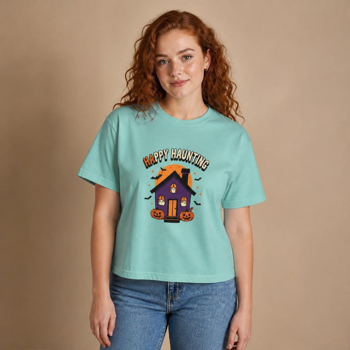 Model wearing the chalky mint Happy Haunting Haunted House boxy crop tee, studio photo (Color: Chalky Mint)