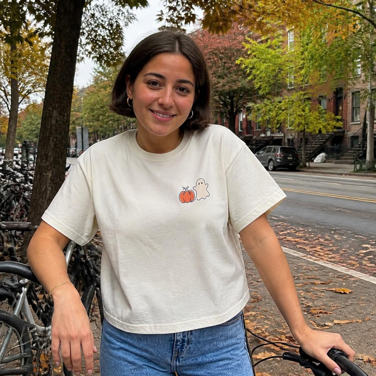 Woman wearing the ivory Pumpkin Ghost boxy crop tee, lifestyle photo (Color: Ivory)
