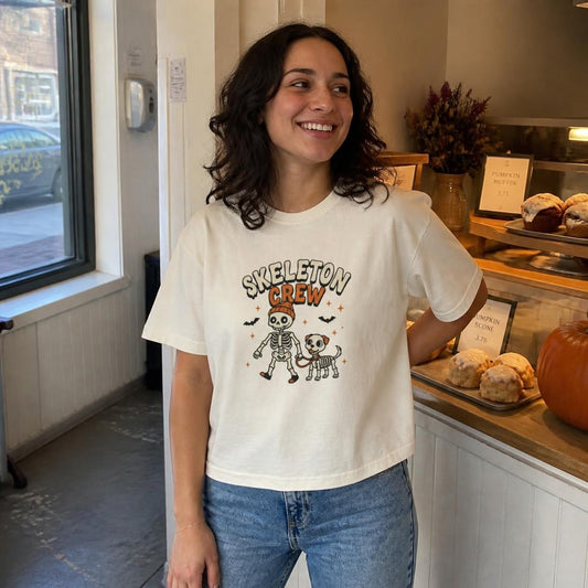 Woman wearing the ivory Skeleton Crew Dog boxy crop tee, lifestyle photo (Color: Ivory)