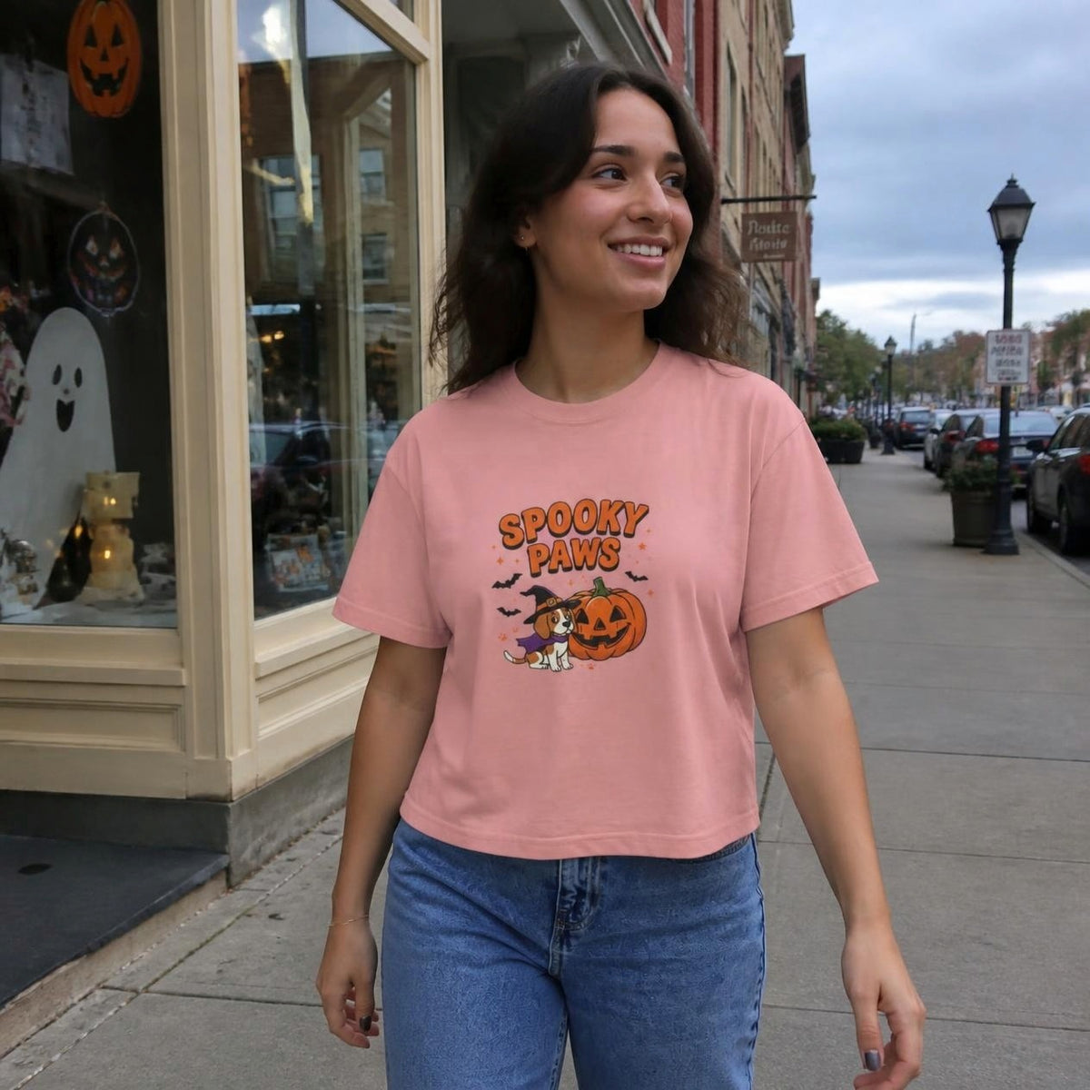 Woman wearing the peachy Spooky Paws Dog boxy crop tee, lifestyle photo (Color: Peachy)
