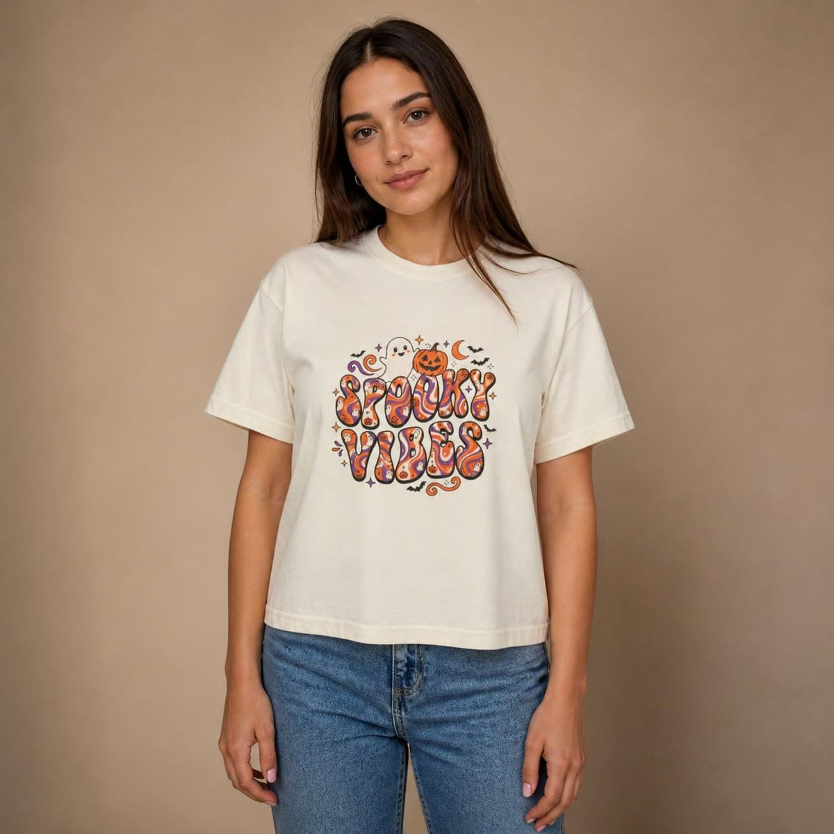 Model wearing the ivory Spooky Vibes Retro boxy crop tee, studio photo (Color: Ivory)