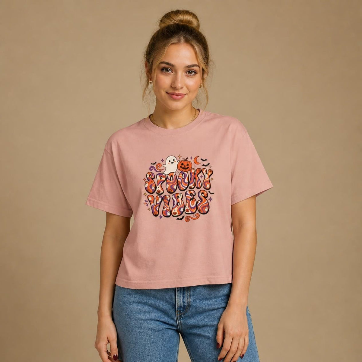Model wearing the peachy Spooky Vibes Retro boxy crop tee, studio photo (Color: Peachy)