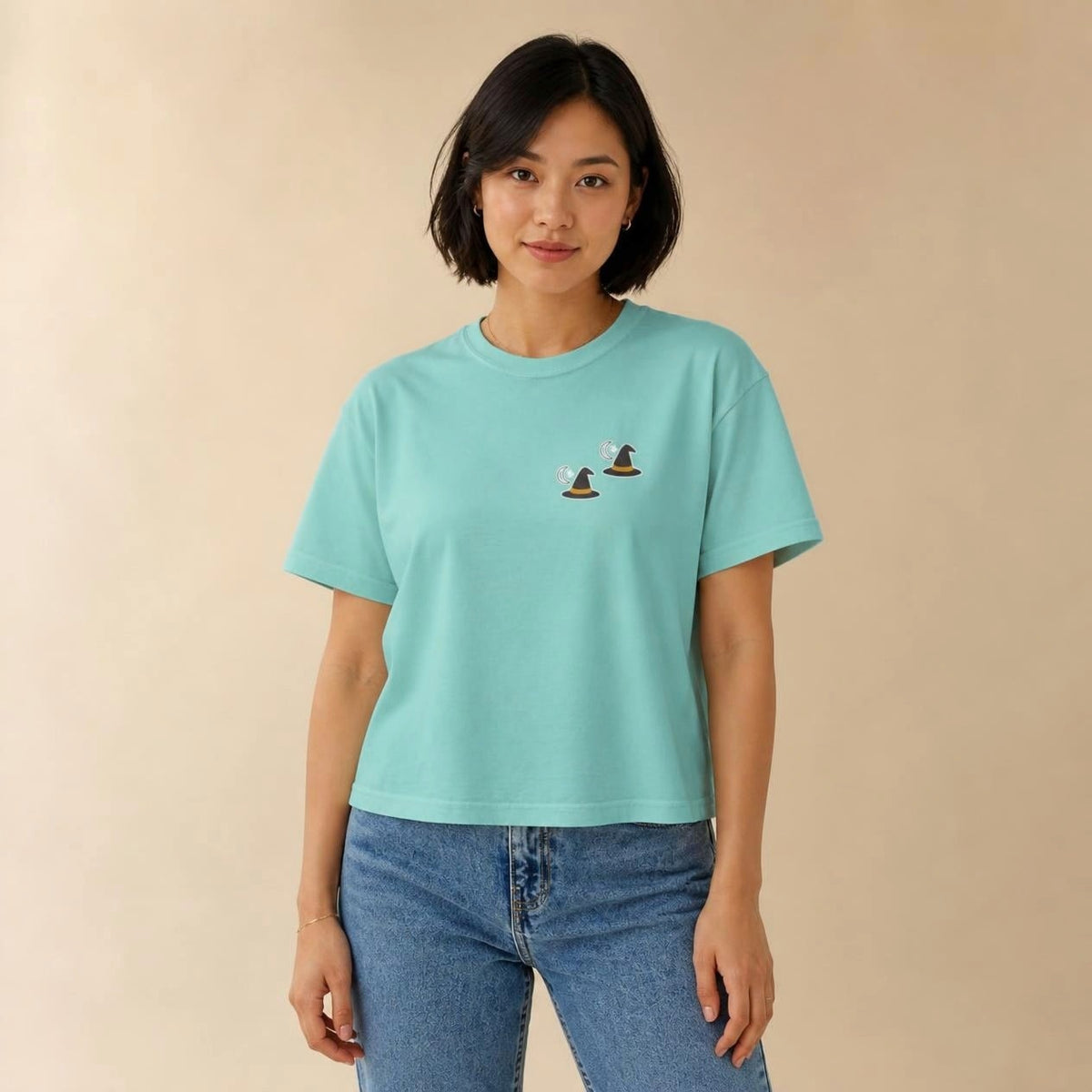 Model wearing the chalky mint Witch Hat boxy crop tee, studio photo (Color: Chalky Mint)