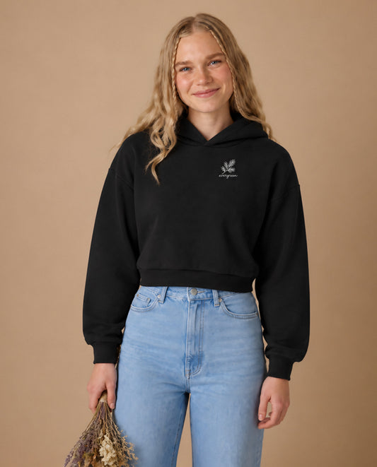 Evergreen minimalist crop hoodie for women in Black, worn by model, studio photo