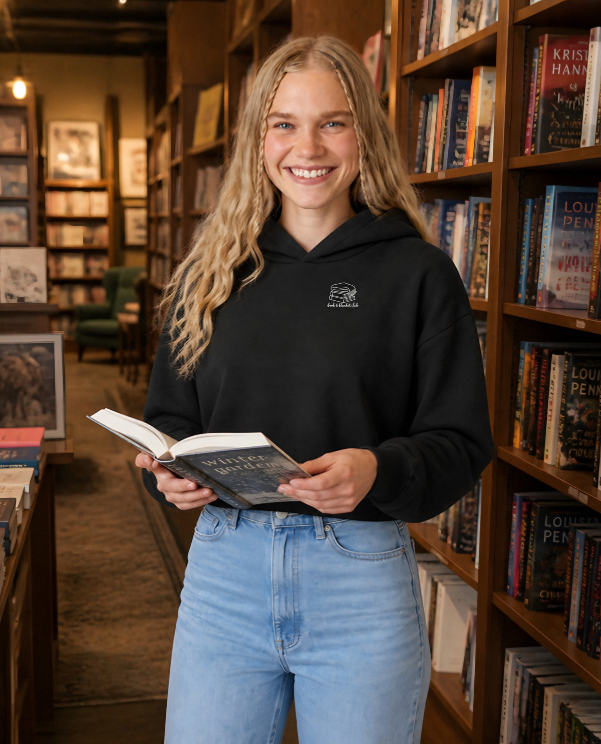 Book & Blanket Club minimalist crop hoodie for women in Black, worn by model, lifestyle photo