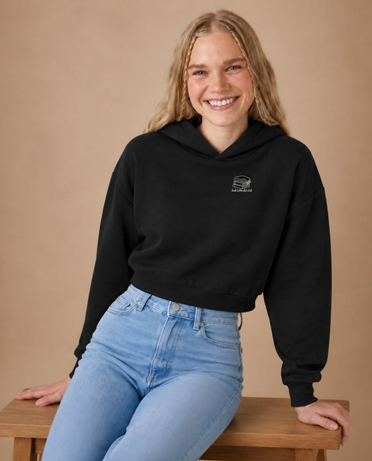 Book & Blanket Club minimalist crop hoodie for women in Black, worn by model, studio photo