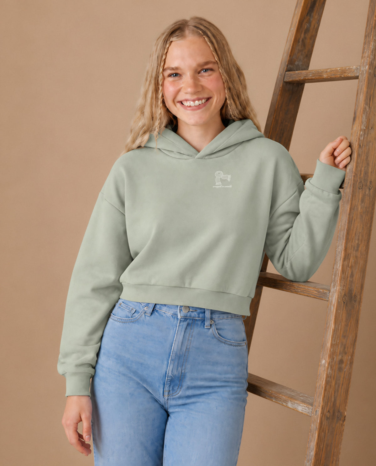Wrapped in Warmth minimalist crop hoodie for women in Matcha, worn by model, studio photo