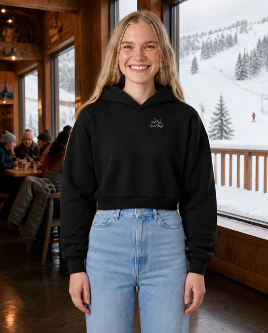 Snow Days minimalist crop hoodie for women in Black, worn by model, lifestyle photo