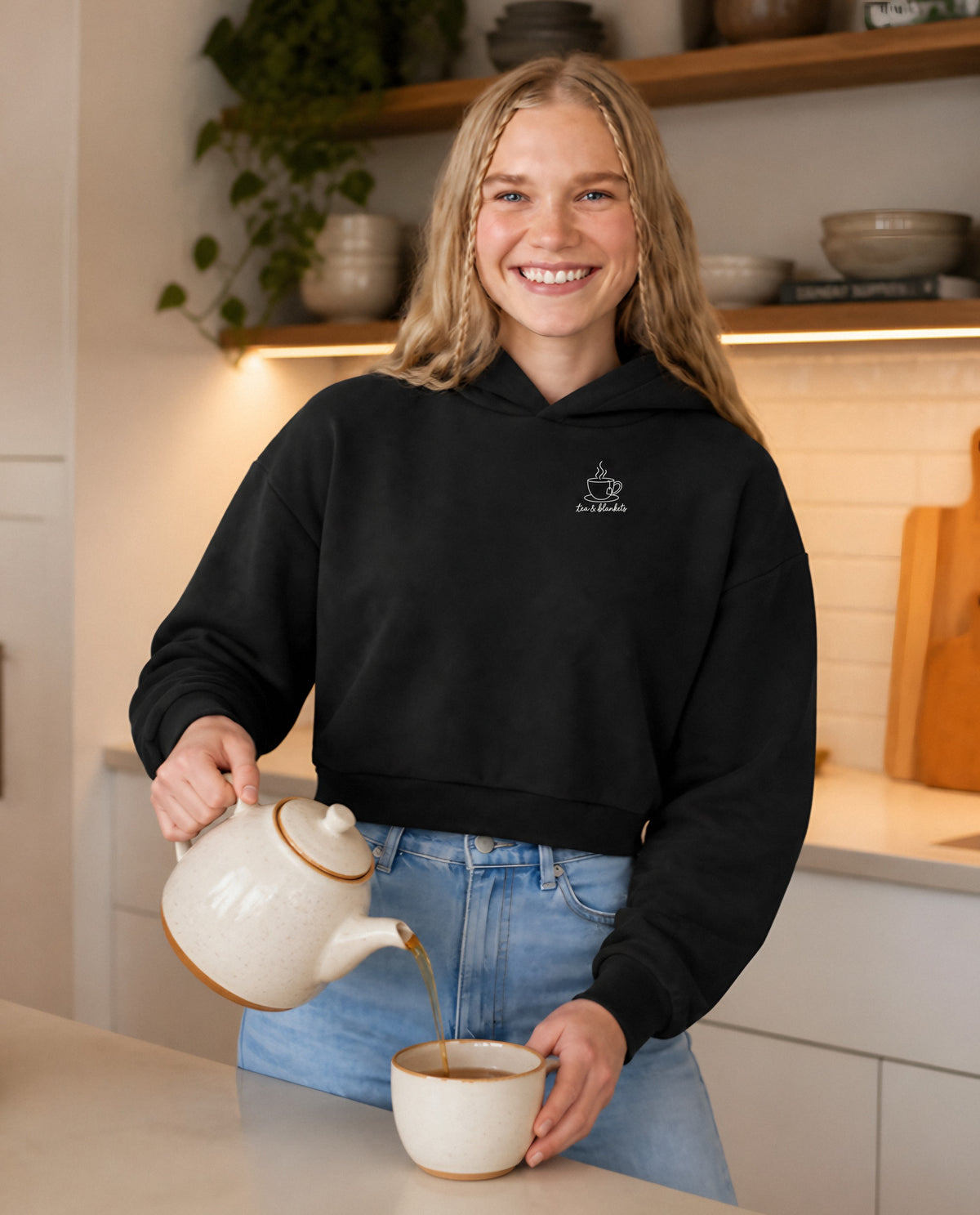 Tea & Blankets minimalist crop hoodie for women in Black, worn by model, lifestyle photo