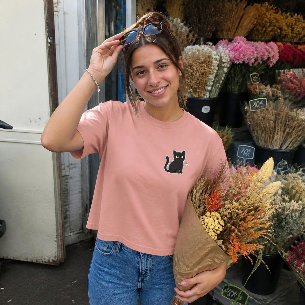 Woman wearing the peachy Black Cat boxy crop tee, lifestyle photo (Color: Peachy)