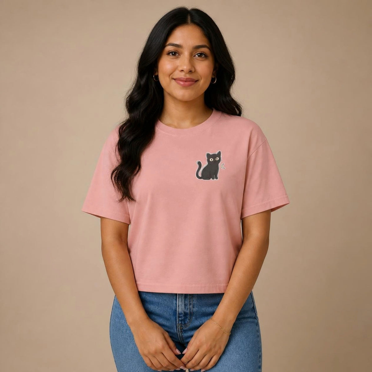 Model wearing the peachy Black Cat boxy crop tee, studio photo (Color: Peachy)