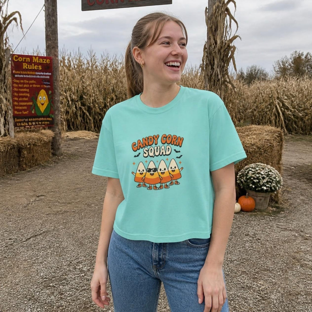 Woman wearing the chalky mint Candy Corn Squad boxy crop tee, lifestyle photo (Color: Chalky Mint)