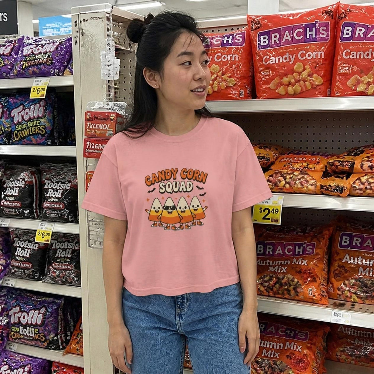 Woman wearing the peachy Candy Corn Squad boxy crop tee, lifestyle photo (Color: Peachy)
