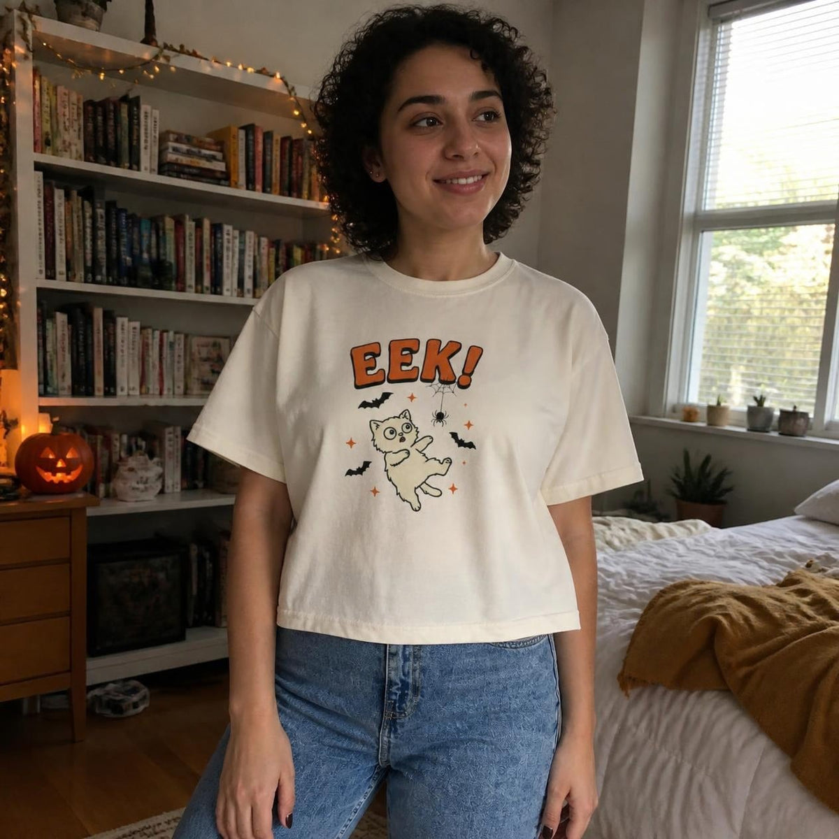 Woman wearing the ivory Eek! Scared Cat boxy crop tee, lifestyle photo (Color: Ivory)