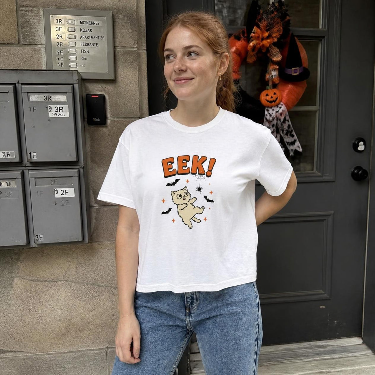 Woman wearing the white Eek! Scared Cat boxy crop tee, lifestyle photo (Color: White)