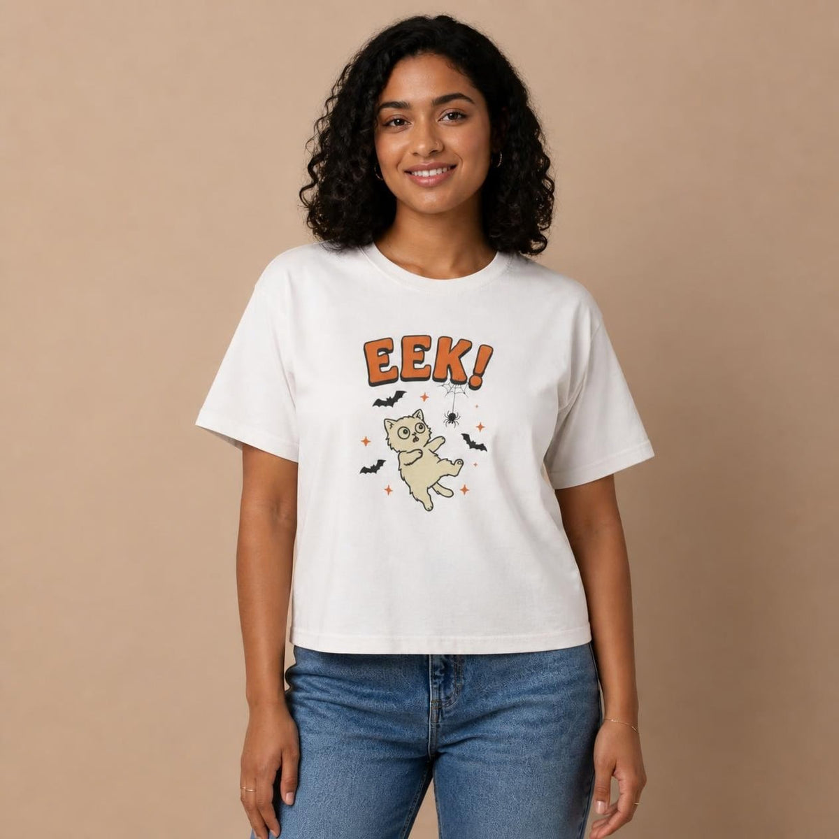 Model wearing the white Eek! Scared Cat boxy crop tee, studio photo (Color: White)