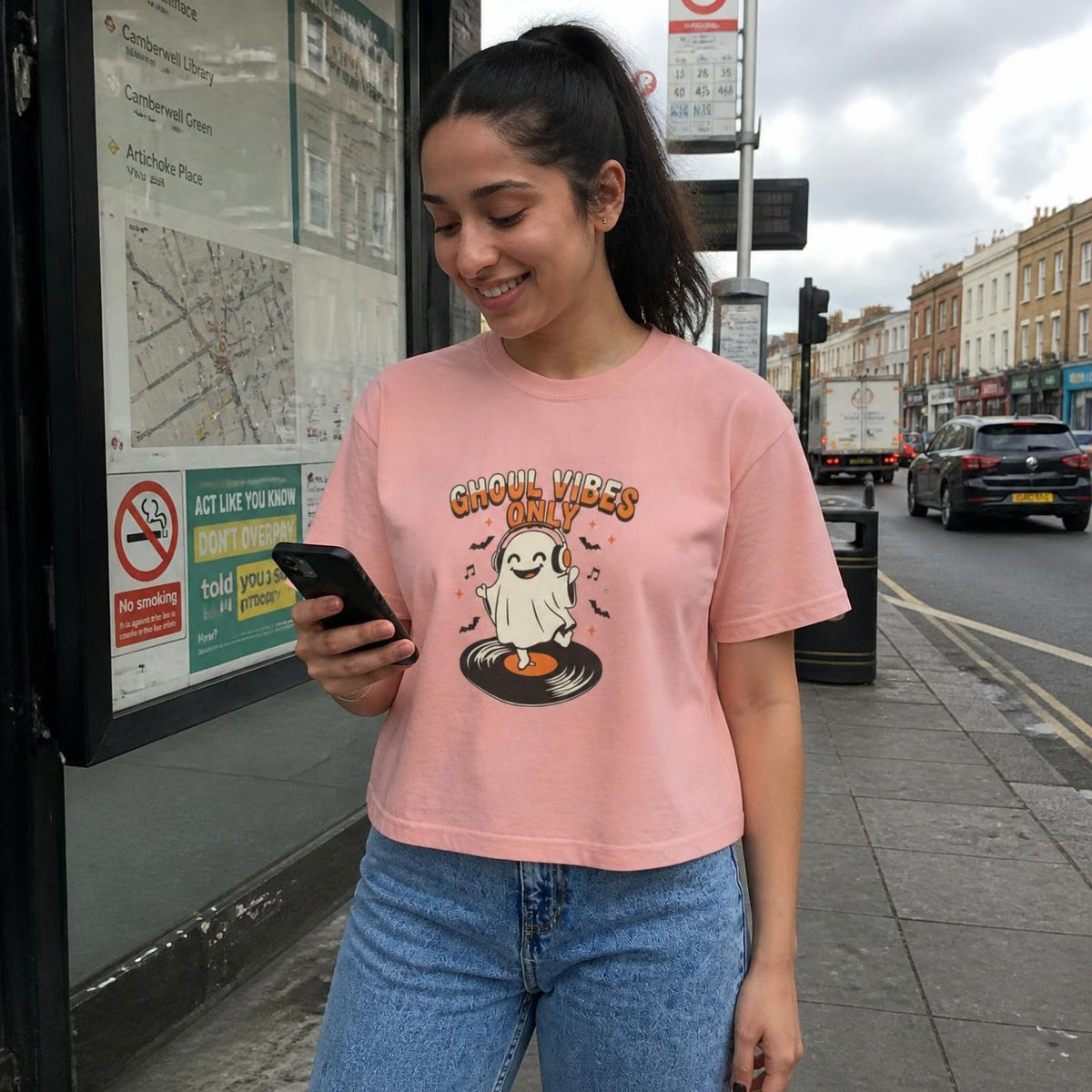 Woman wearing the peachy Ghoul Vibes Only Ghost boxy crop tee, lifestyle photo (Color: Peachy)