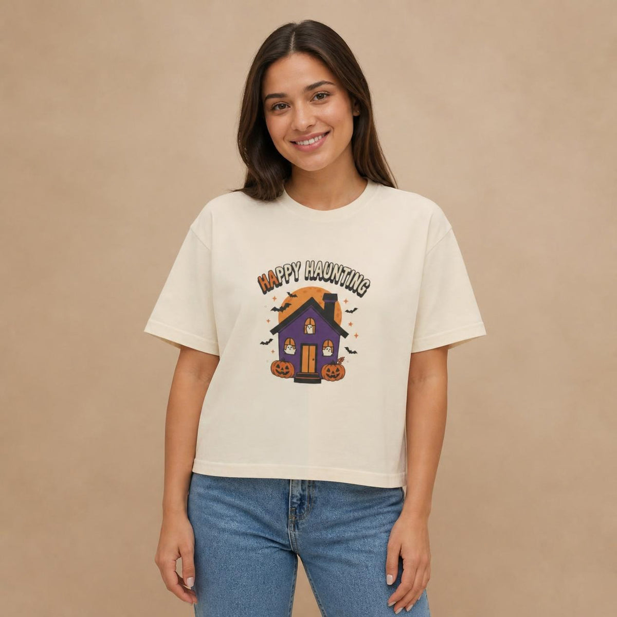 Model wearing the ivory Happy Haunting Haunted House boxy crop tee, studio photo (Color: Ivory)