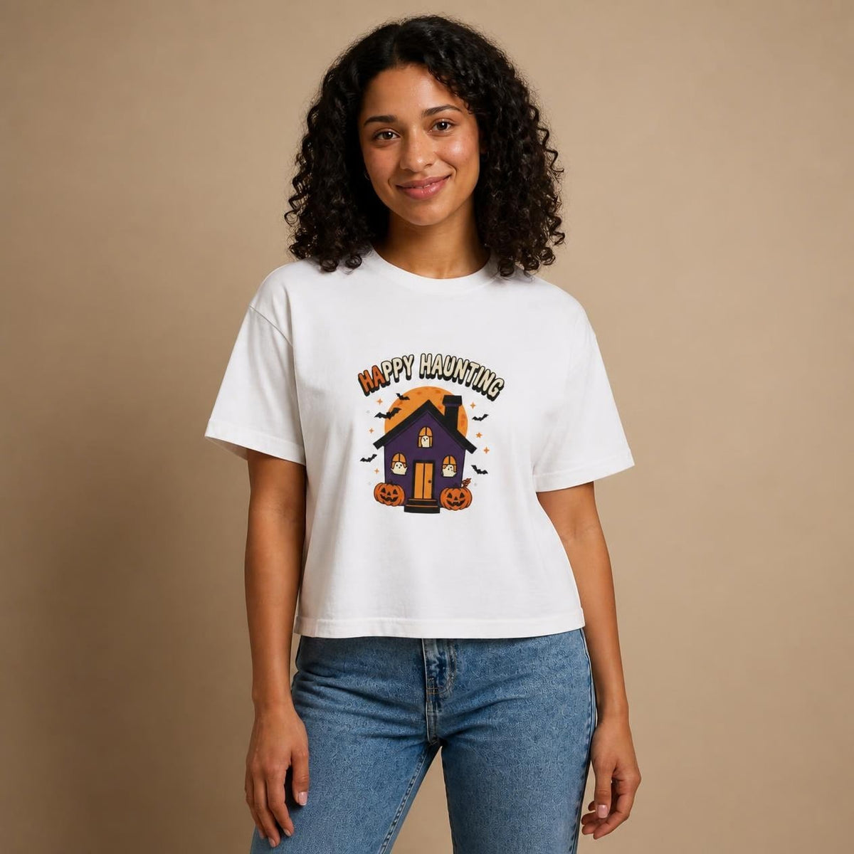 Model wearing the white Happy Haunting Haunted House boxy crop tee, studio photo (Color: White)