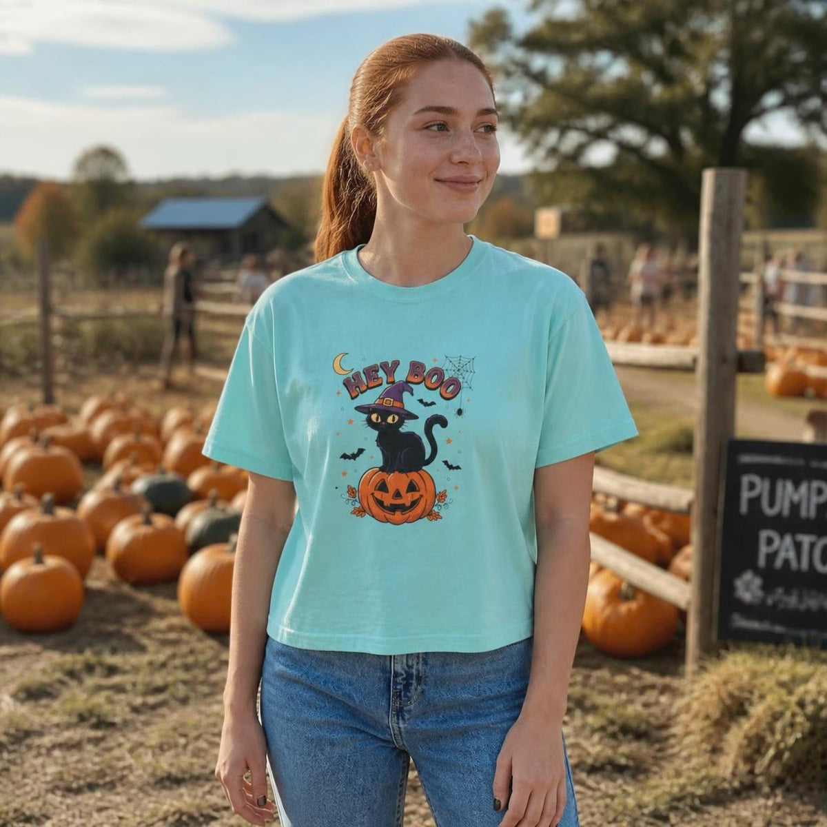 Woman wearing the chalky mint Hey Boo Black Cat boxy crop tee, lifestyle photo (Color: Chalky Mint)