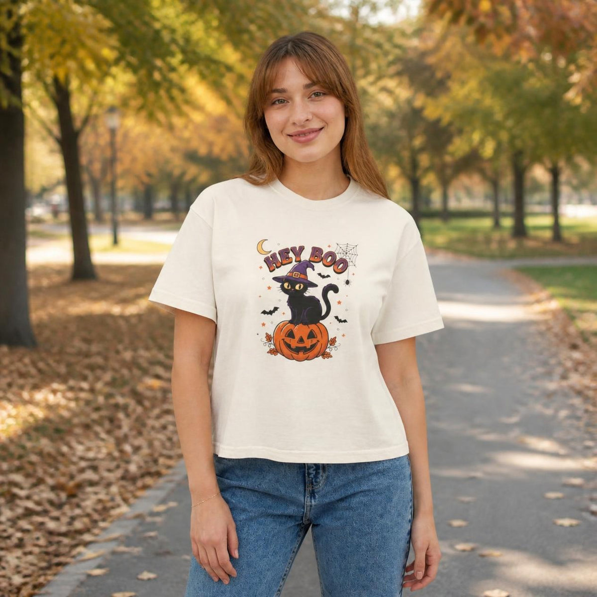 Woman wearing the ivory Hey Boo Black Cat boxy crop tee, lifestyle photo (Color: Ivory)
