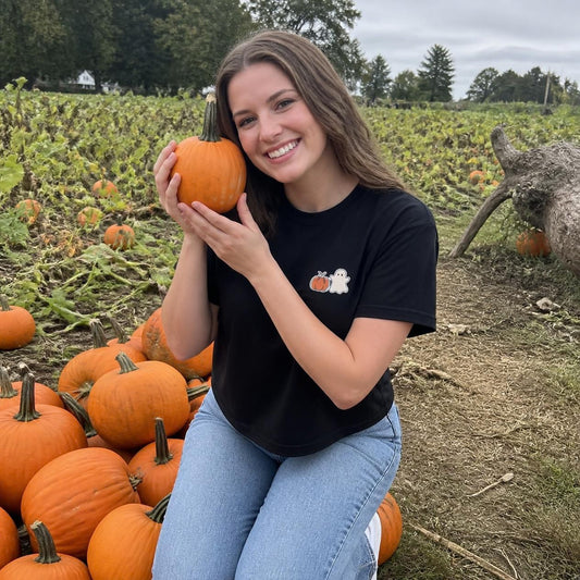 Woman wearing the black Pumpkin Ghost boxy crop tee, lifestyle photo (Color: Black)