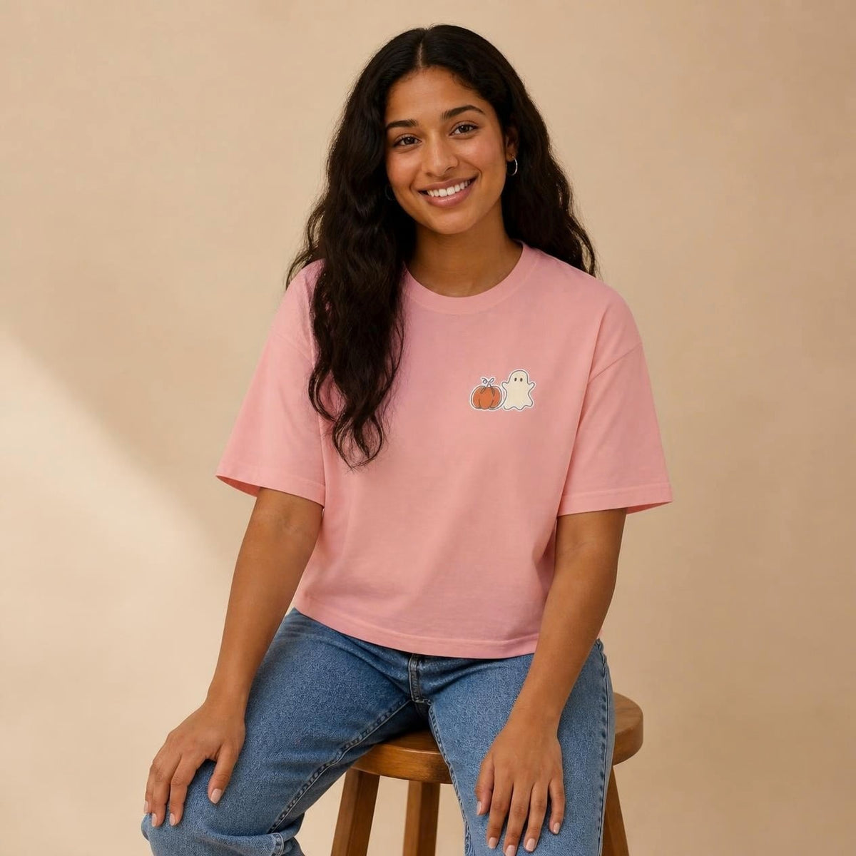 Model wearing the peachy Pumpkin Ghost boxy crop tee, studio photo (Color: Peachy)