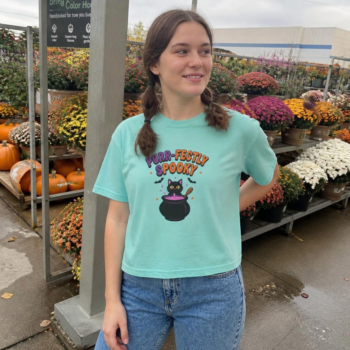 Woman wearing the chalky mint Purr-fectly Spooky Black Cat boxy crop tee, lifestyle photo (Color: Chalky Mint)