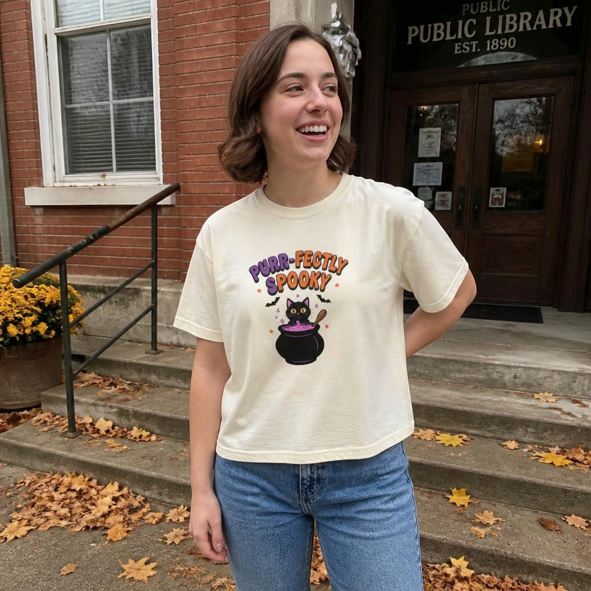 Woman wearing the ivory Purr-fectly Spooky Black Cat boxy crop tee, lifestyle photo (Color: Ivory)