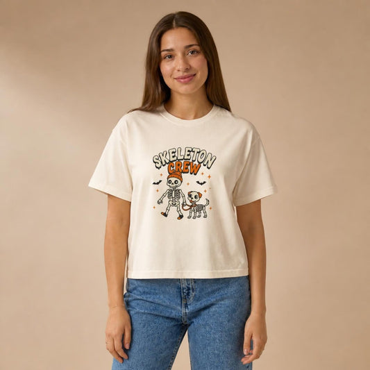 Model wearing the ivory Skeleton Crew Dog boxy crop tee, studio photo (Color: Ivory)