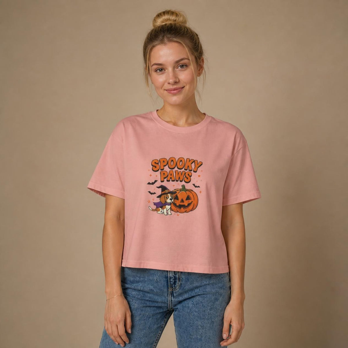 Model wearing the peachy Spooky Paws Dog boxy crop tee, studio photo (Color: Peachy)