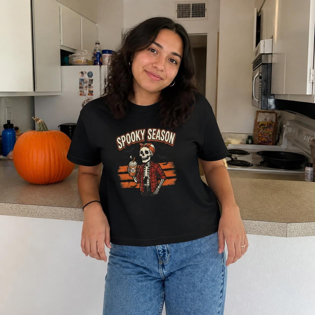 Woman wearing the black Spooky Season Skeleton boxy crop tee, lifestyle photo (Color: Black)
