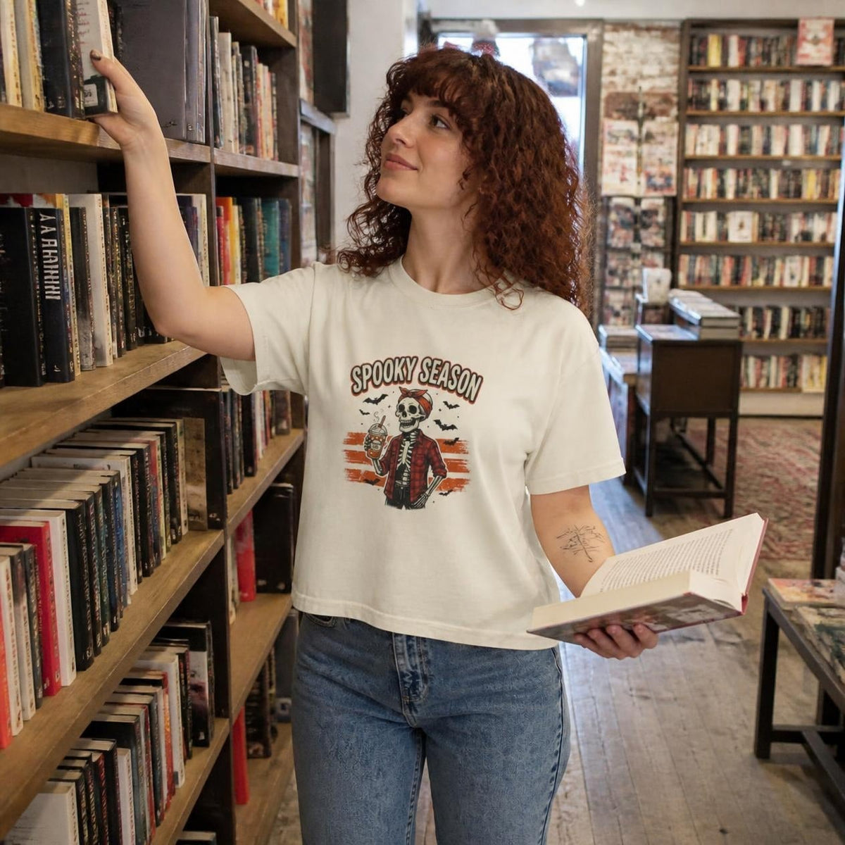 Woman wearing the ivory Spooky Season Skeleton boxy crop tee, lifestyle photo (Color: Ivory)
