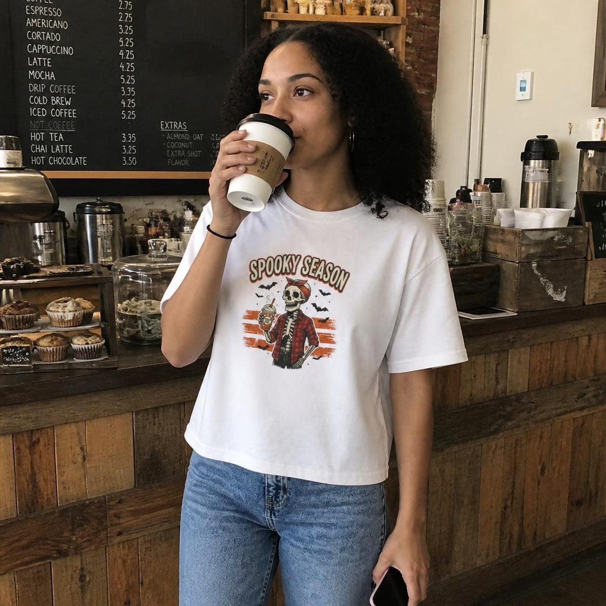 Woman wearing the white Spooky Season Skeleton boxy crop tee, lifestyle photo (Color: White)