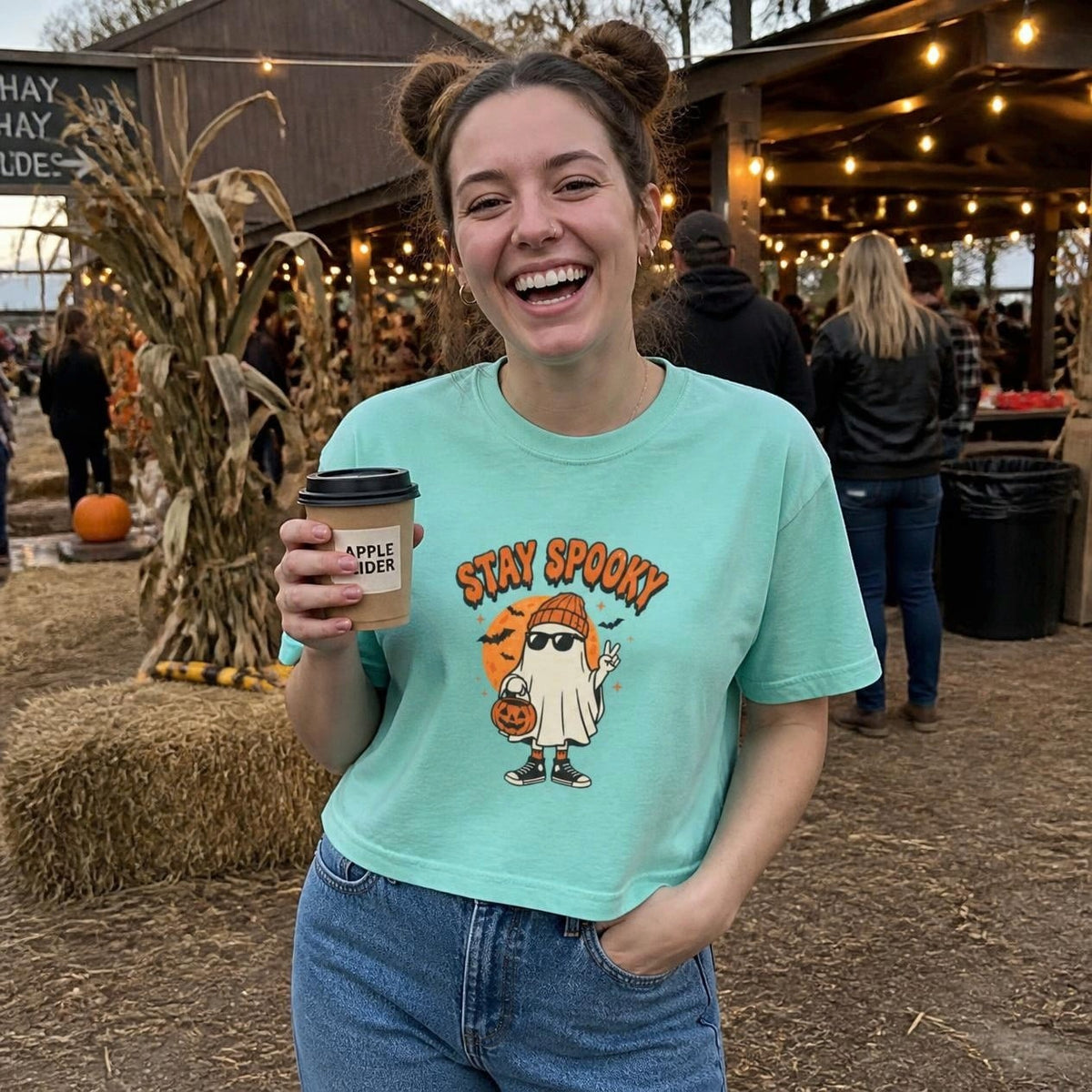 Woman wearing the chalky mint Stay Spooky Ghost boxy crop tee, lifestyle photo (Color: Chalky Mint)