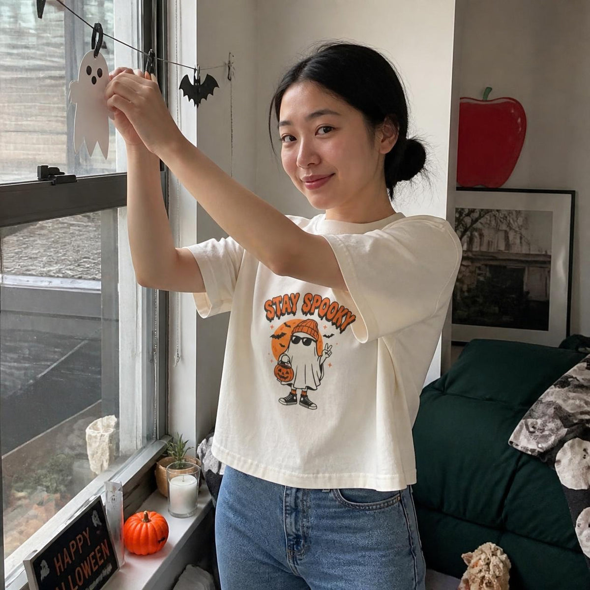 Woman wearing the ivory Stay Spooky Ghost boxy crop tee, lifestyle photo (Color: Ivory)