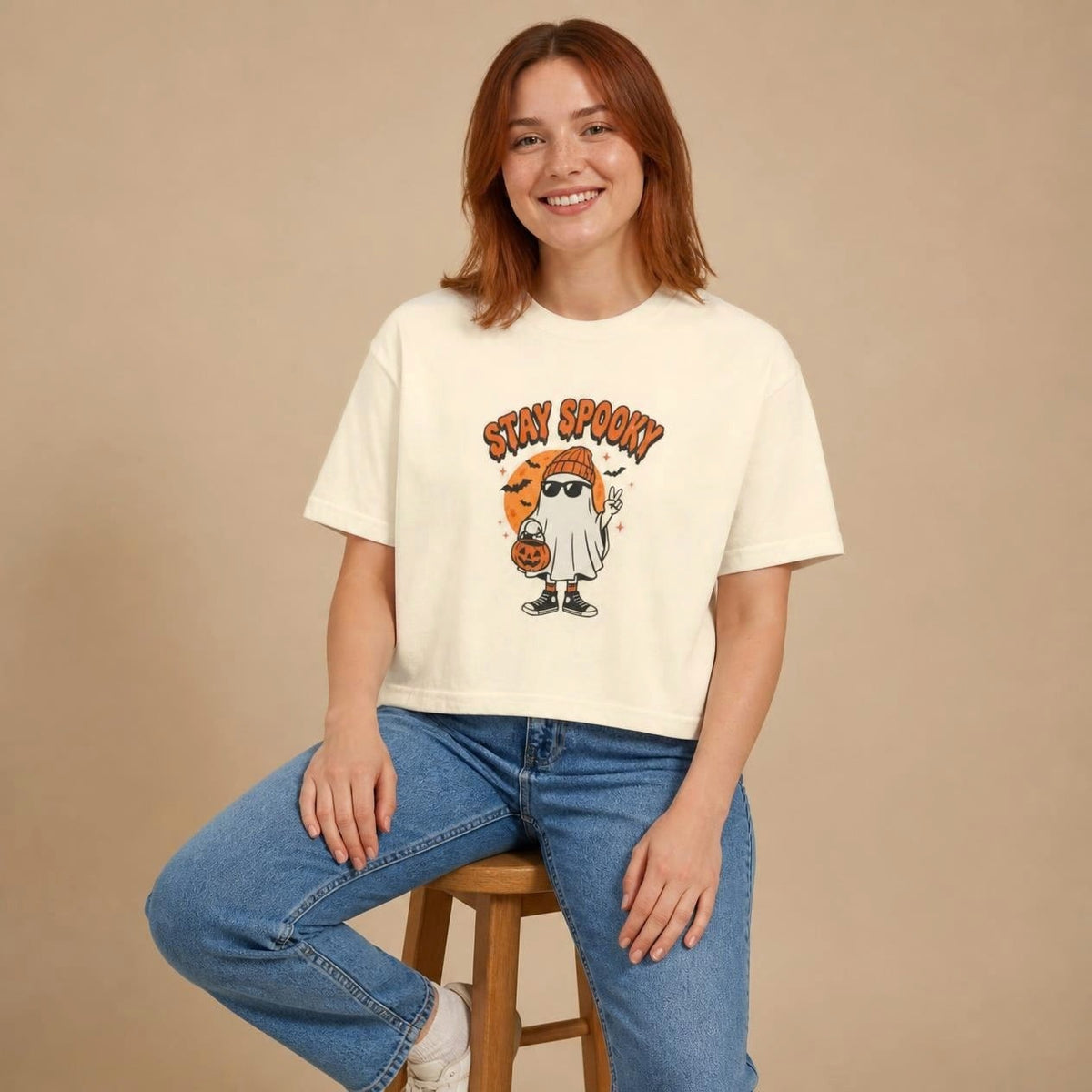 Model wearing the ivory Stay Spooky Ghost boxy crop tee, studio photo (Color: Ivory)