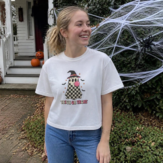 Woman wearing the white Trick or Treat Checkered Ghost boxy crop tee, lifestyle photo (Color: White)