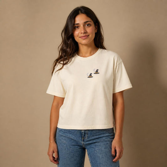 Model wearing the ivory Witch Hat boxy crop tee, studio photo (Color: Ivory)